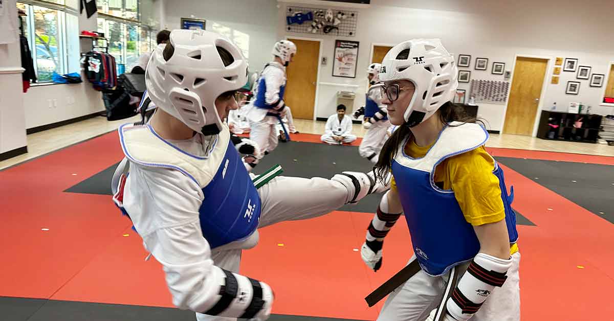 Teens are sparring in Taekwondo class
