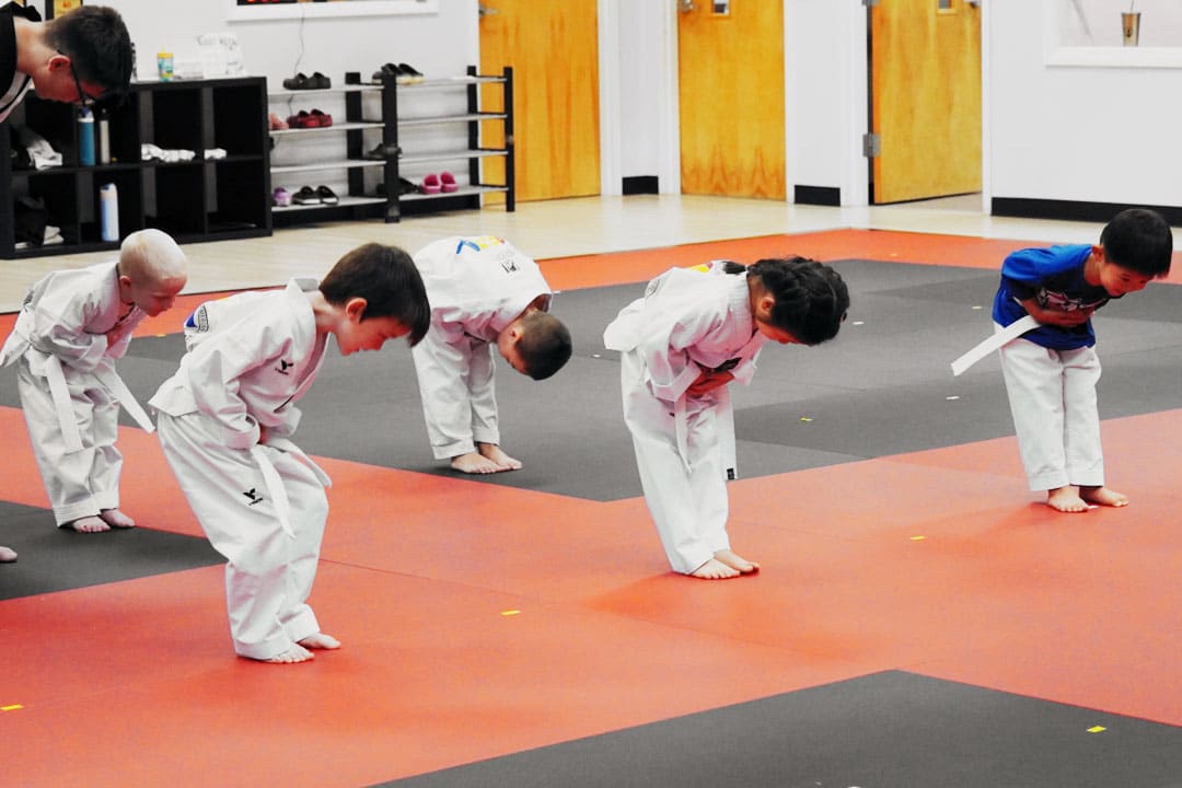 Preschool martial arts students bowing to each other during Taekwondo class at ABBA Martial Arts in Peachtree City.