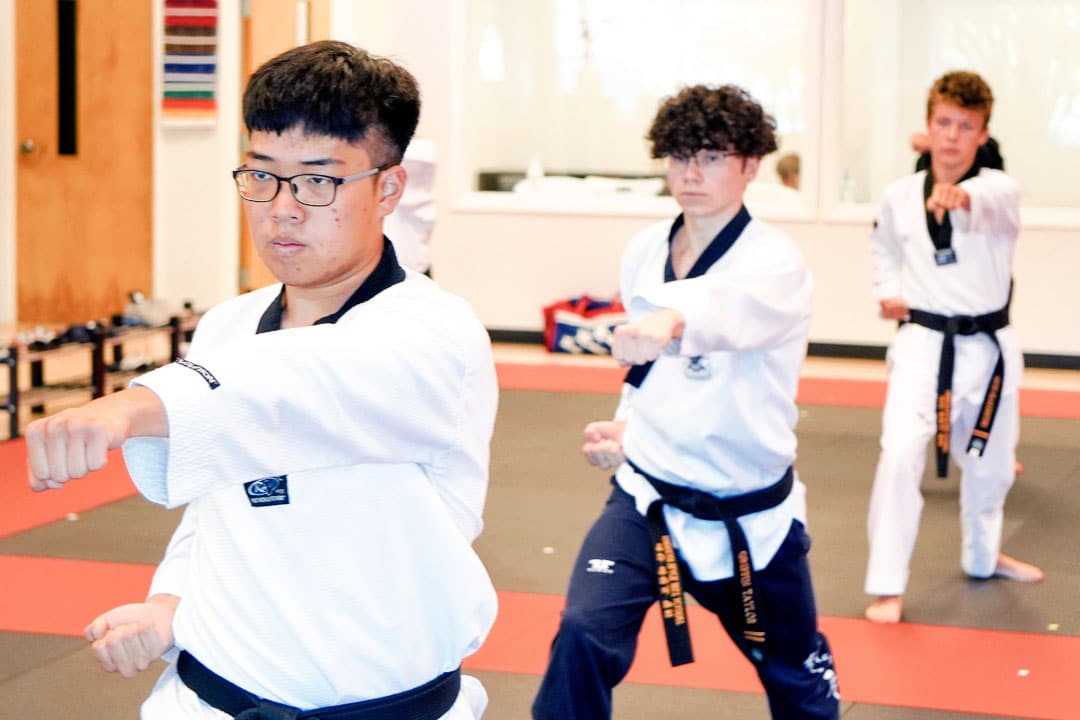 Teen martial arts students practicing traditional Taekwondo with discipline and focus at ABBA Martial Arts in Peachtree City