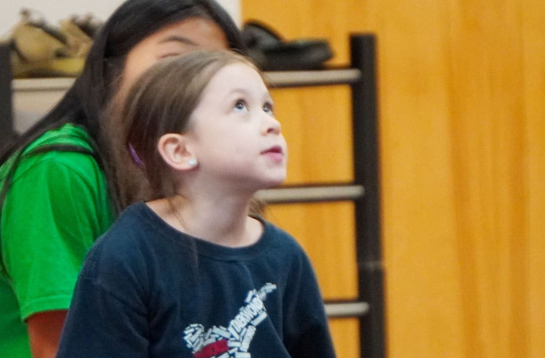 Child attentively looking at martial arts instructor during a life-skills lesson at ABBA Martial Arts in Peachtree City.