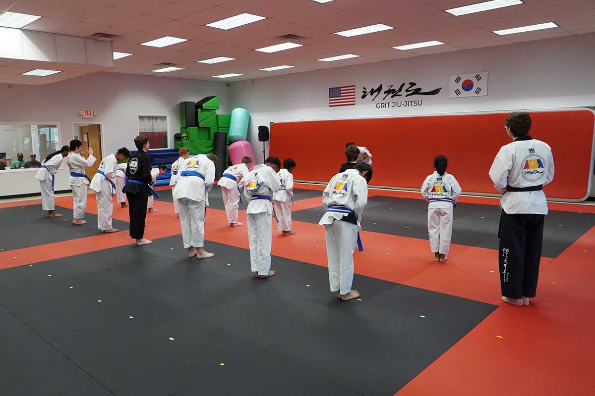 all students are bowing to a instructor before the class