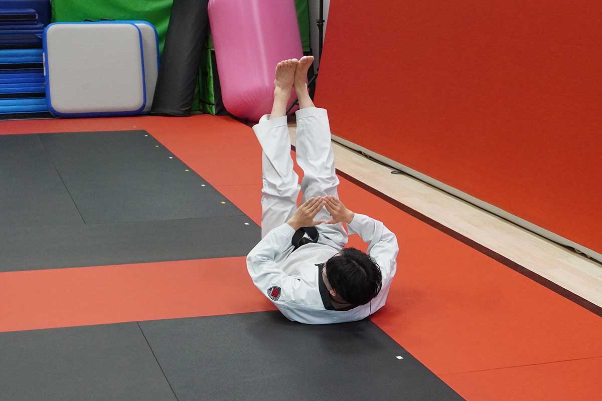 an instructor is demonstrating a break fall