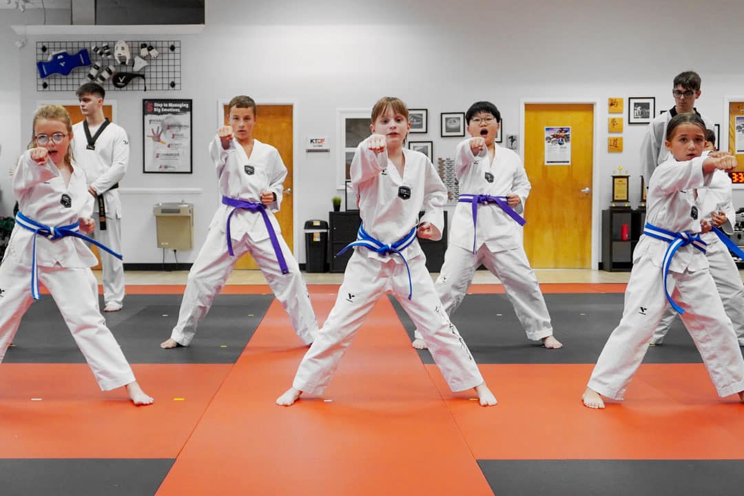 Students practicing martial arts in a structured class, demonstrating focus and discipline.