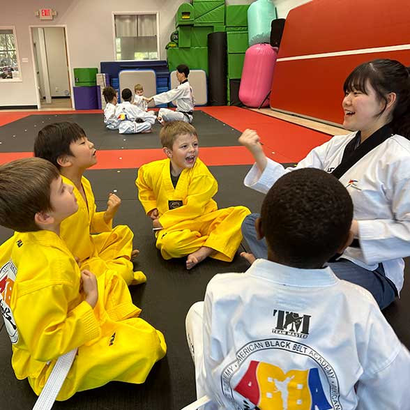 a kids group is practice Taekwondo with an instructor