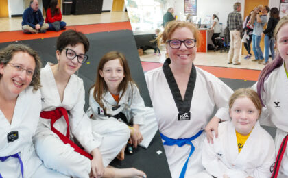 Parents and children training together in a Taekwondo class in Peachtree City
