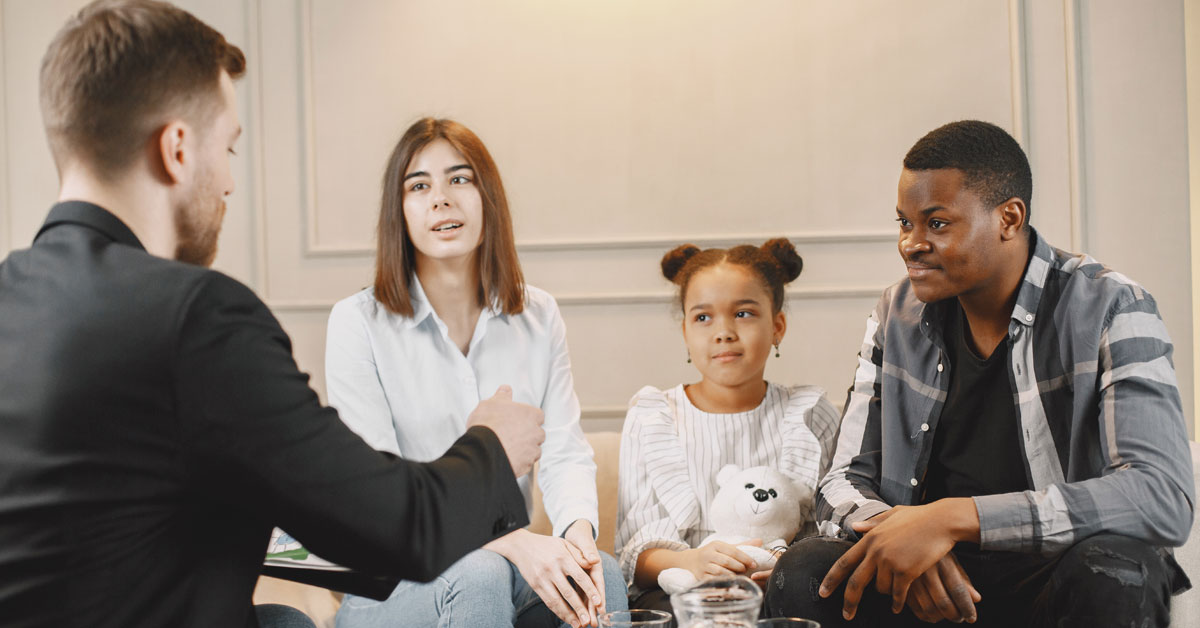 Parents and child meeting with school counselor to resolve bullying issues &ndash; collaboration and support | Taekwondo school Peachtree City

